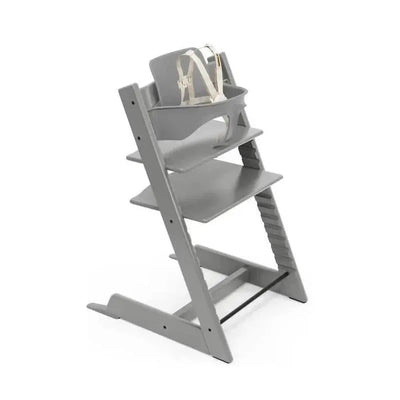 Stokke Tripp Trapp® High Chair in Storm Grey, featuring adjustable seating and a safety harness.
