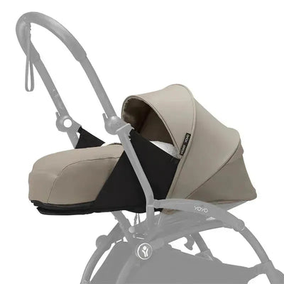 Stokke Yoyo 0+ Newborn Pack in taupe, featuring a soft cushioned infant carrycot attached to a stroller frame.