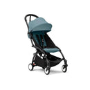 Stokke Yoyo³ stroller in aqua with a black frame, featuring a padded seat and canopy, designed for children 6 months and older.