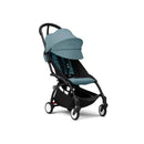 Stokke Yoyo³ stroller with a black frame and aqua seat, designed for children 6 months and older.