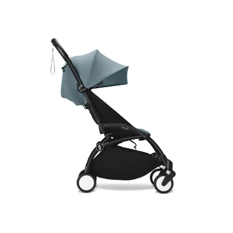 Stokke Yoyo³ stroller in black frame with aqua canopy, featuring a compact design for easy mobility.