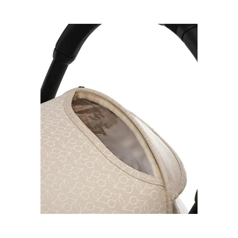 Stokke Yoyo³ stroller leg rest in a light beige fabric with logo pattern, partially open revealing its interior.