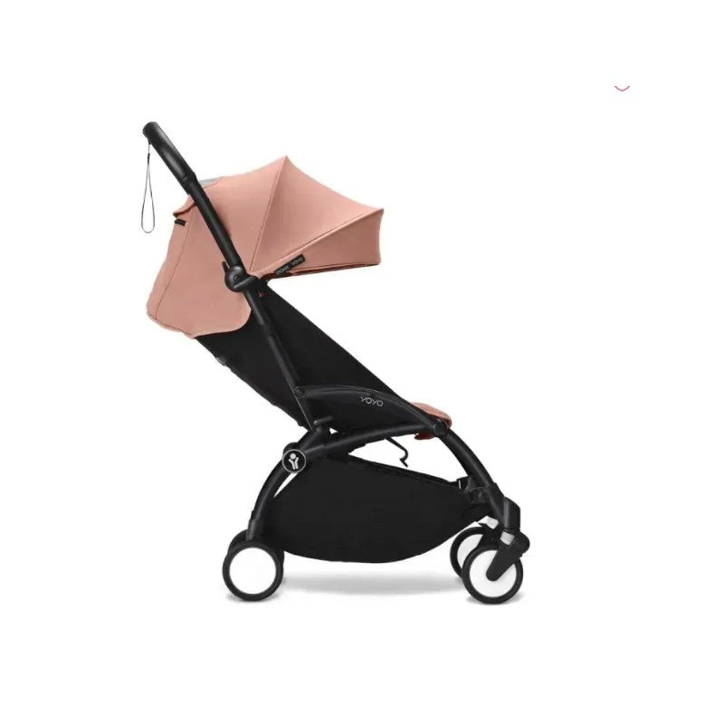 Stokke Yoyo³ stroller in black frame with a ginger canopy, designed for children 6 months and older.
