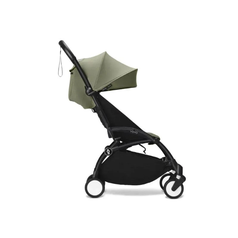 Stokke Yoyo³ stroller with a black frame and olive canopy, designed for children 6 months and older.