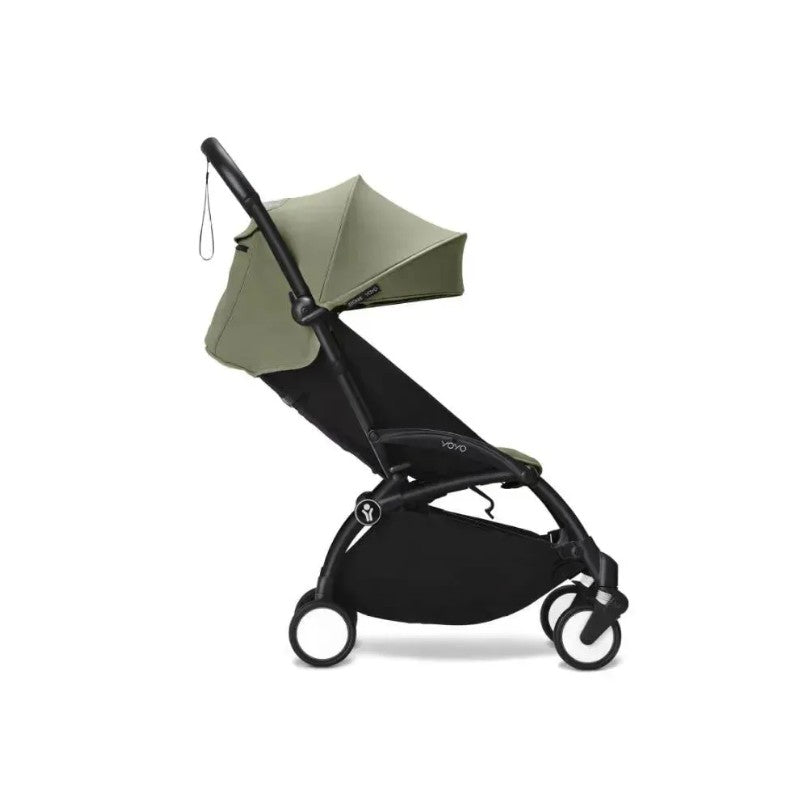 Stokke Yoyo³ stroller in black frame with olive canopy, designed for children 6 months and older.