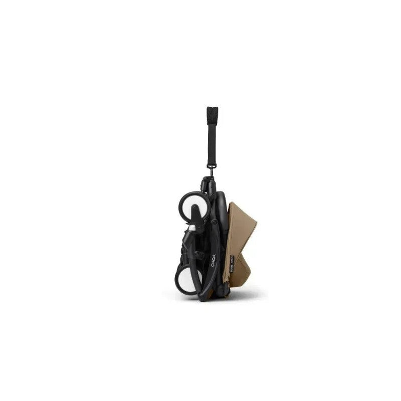 Stokke Yoyo³ stroller in black frame with toffee leg rest, displayed in a folded position for easy transport.