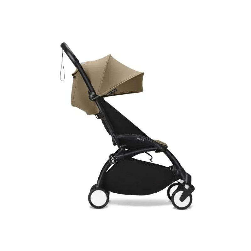Stokke Yoyo³ Stroller 6+, featuring a black frame and toffee-colored canopy, designed for babies over 6 months.