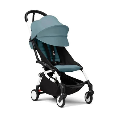 Stokke Yoyo° stroller bundle with a black and white frame and aqua color pack, designed for newborns and toddlers.