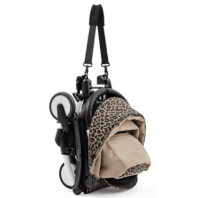 Stokke Yoyo³ stroller bundle in black and white frame with a leopard print color pack, folded for easy transport.