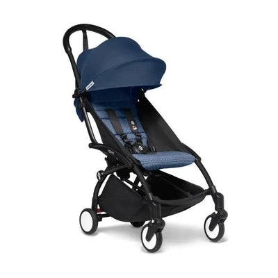 Stokke Yoyo³ stroller with a navy color pack, featuring a black frame, compact design, and safety harness.