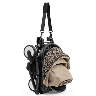 Stokke Yoyo³ stroller in a compact, folded position with a black frame and leopard print color pack.