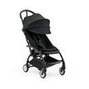 Compact Yoyo5 stroller with a black frame and fabric, featuring a large canopy and safety harness, designed for easy transport.