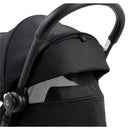 Compact stroller featuring a black frame and canopy, with a mesh viewing window for ventilation.