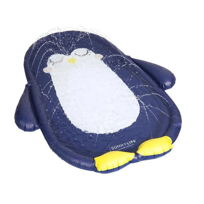 Inflatable water mat shaped like a penguin, featuring a blue design with a white belly and yellow feet, spraying water.