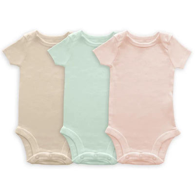 Three short-sleeved organic cotton bodysuits in soft pink, jadeite, and sand dollar colors.