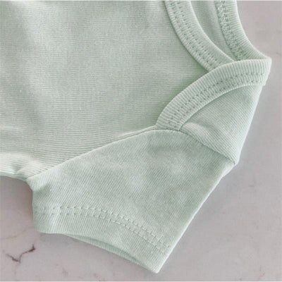 Light green bodysuit from Swaddle Designs with soft fabric and ribbed texture, part of a three-pack set.