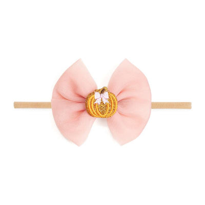 Tulle bow baby headband featuring a pink bow with a glittery orange pumpkin centerpiece and small pink bows.