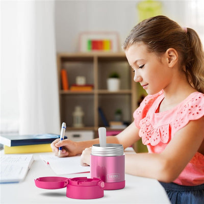 Thermos FUNtainer 10 oz food jar in pink, with a child using a spoon, surrounded by stationery on a desk.