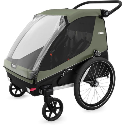 Thule Courier Child Bike Trailer in vintage green with a clear front window, suitable for transporting children.
