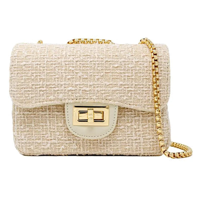 Cream tweed handbag with gold clasp and chain strap, featuring a textured surface and flap closure.