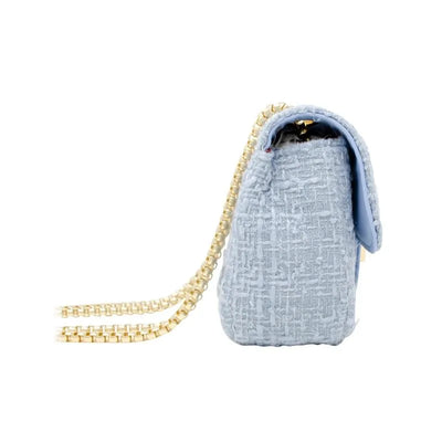 Cream-colored large tweed handbag with a gold chain strap, showcasing a textured surface and flap closure.