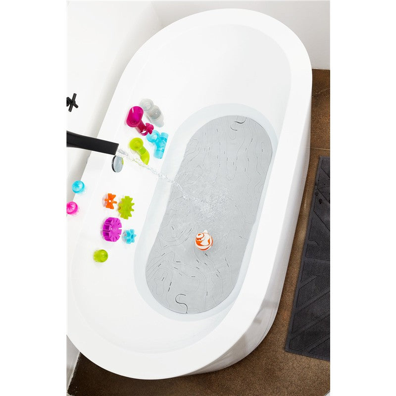 Boon GRIFFLE Gray bathtub mat in an oval tub surrounded by colorful bath toys and water flowing from the faucet.