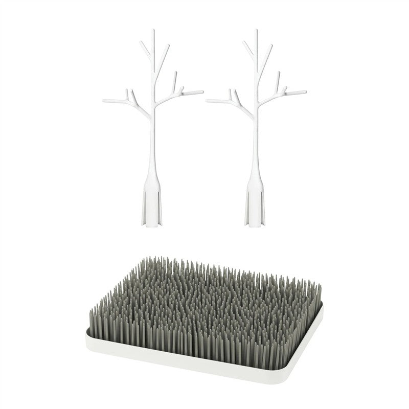 Boon LAWN drying rack featuring a gray grass-like base with two white twig accessories for effective drying.