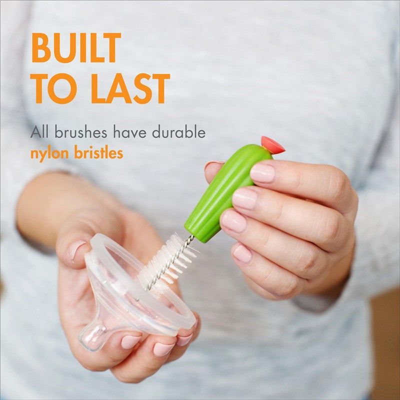 Boon CACTI Bottle Cleaning Brush with durable nylon bristles, being used on a bottle top by a person.