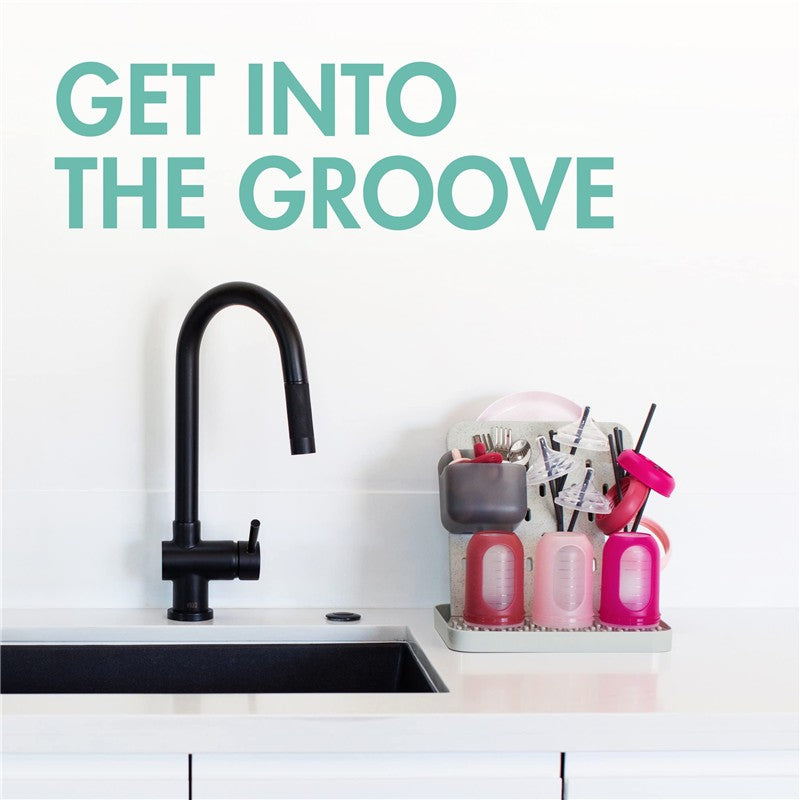 Customizable vertical drying rack with colorful containers for drying bottles and utensils next to a sleek black faucet.