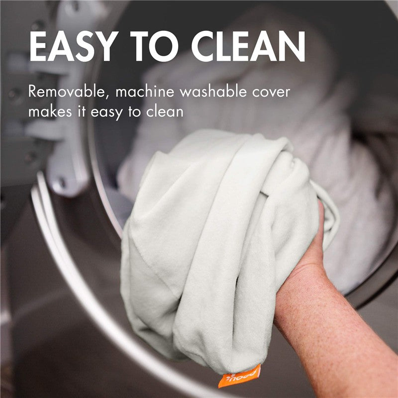 Removable, machine washable cover being placed into a washing machine, emphasizing easy cleaning features.