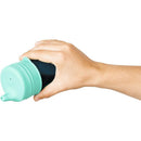 Hand holding a teal Boon SNUG Spout Sippy Cup, showcasing its spout and sleek design.