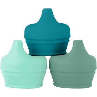 Three silicone sippy lids in shades of mint green and teal stacked artistically, designed for universal use.