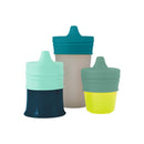 Universal silicone sippy lids in green, three-pack, fits various cups; features soft, colorful spouts for easy drinking.