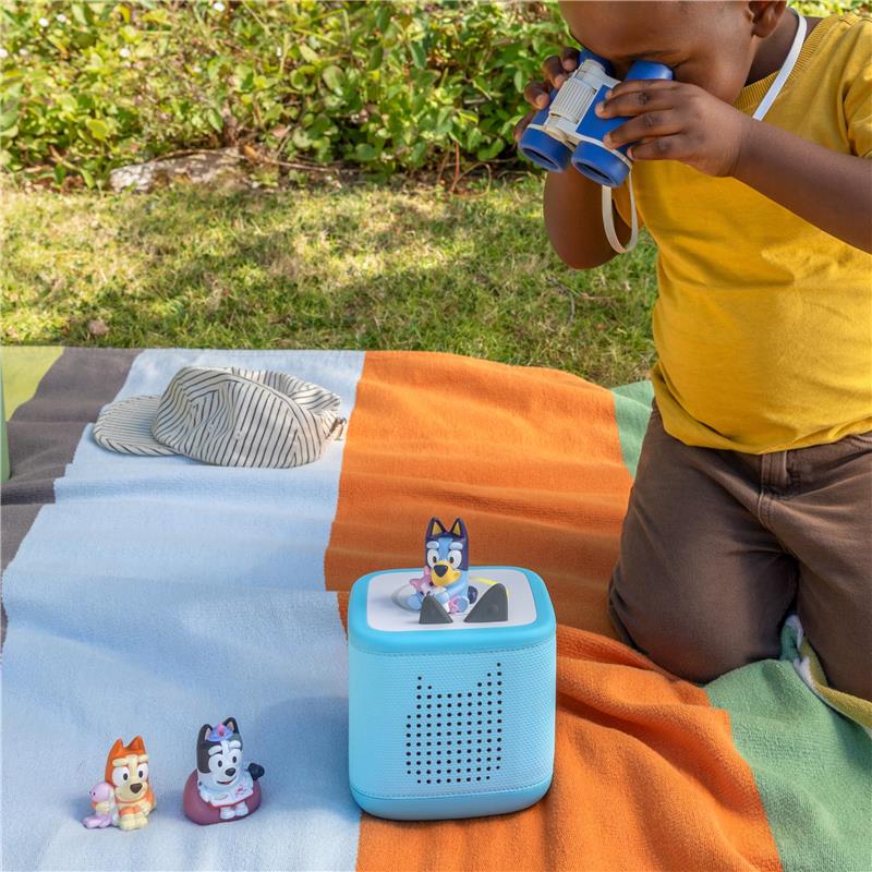Tonies 3Pk Bluey Audio Toy Figurine Set featuring Bluey, Bingo, and Muffin on a colorful blanket with a child using binoculars.