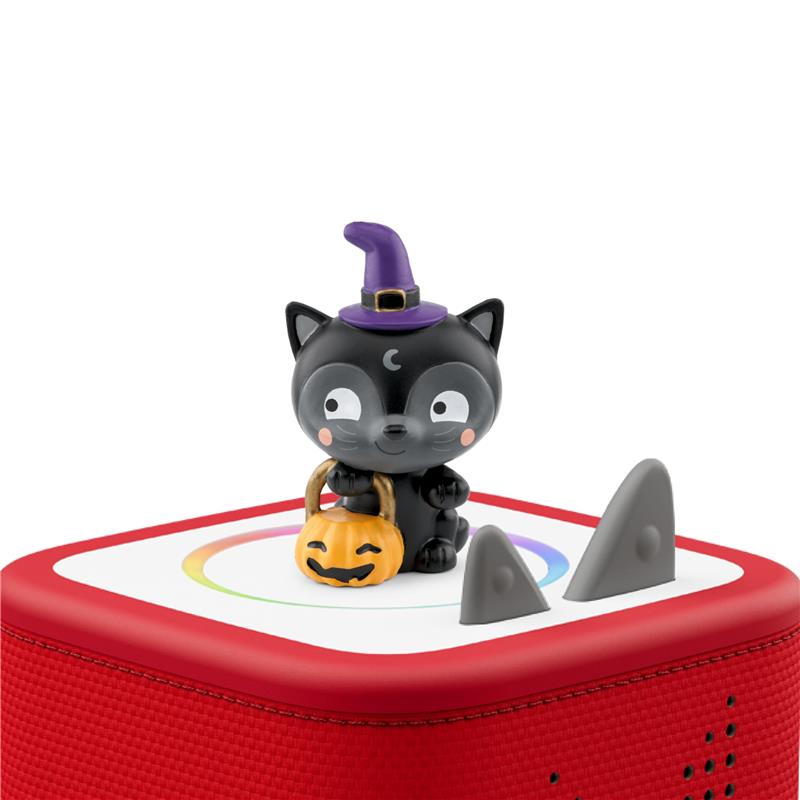 Black cat figurine with a purple witch hat and a pumpkin candy bucket atop a red audio toy, designed for Halloween songs.