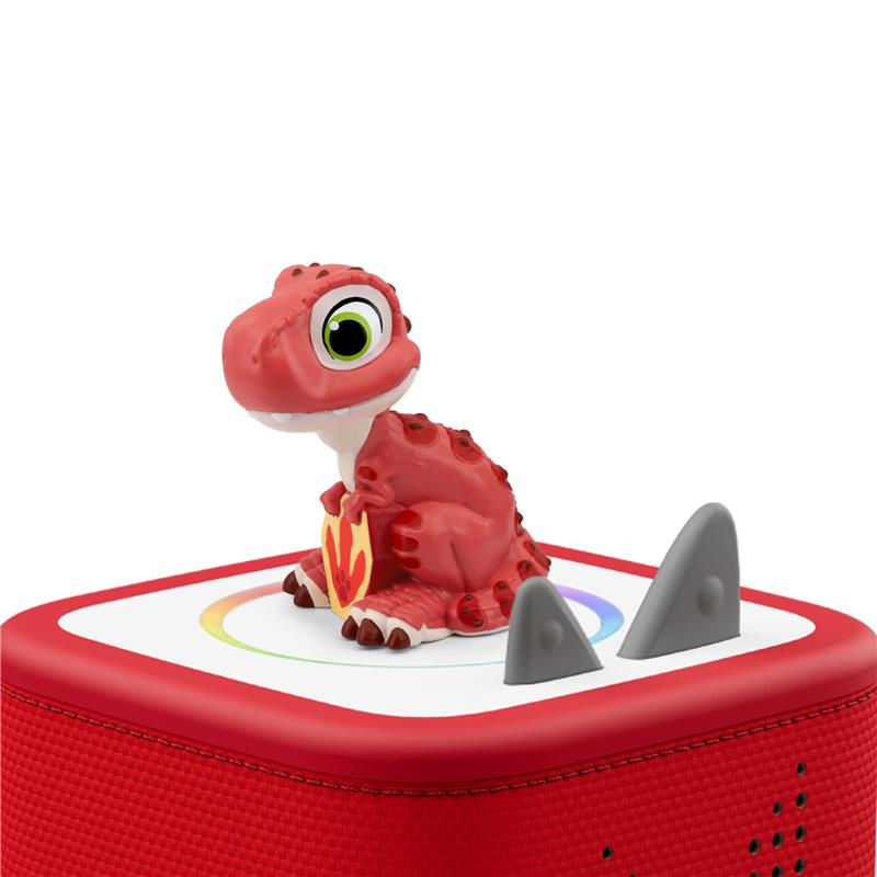Rhubarb, a red dinosaur figurine from PAW Patrol The Dino Movie, sits atop a red audio toy.