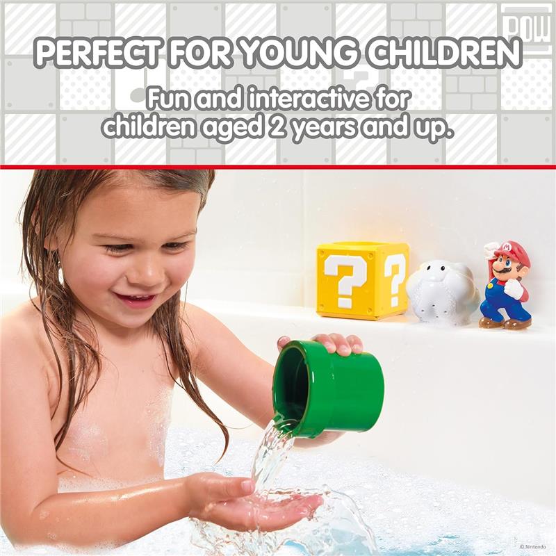 Young child playing with Toomies My Mario Pour & Nest Bath Toy, pouring water from a green cup into their hand.