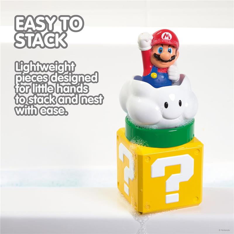 Toomies My Mario Pour & Nest Bath Toy features a Mario character atop a cloud, resting on a question mark block, with bubbly water surrounding.