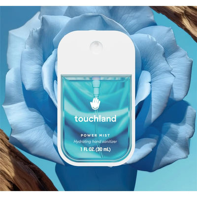 Touchland Blue Sandalwood Power Mist Hydrating Hand Sanitizer in a blue container with floral background, featuring 1 FL OZ (30 mL) size.