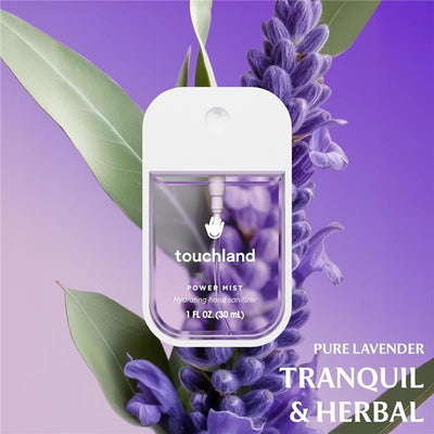 Touchland Pure Lavender Power Mist Hydrating Hand Sanitizer in a sleek container, surrounded by lavender flowers on a gradient purple background.