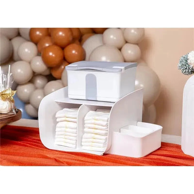 Caddy organizer storing baby diapers, wipes, and accessories; features a white design with compartments for easy access.