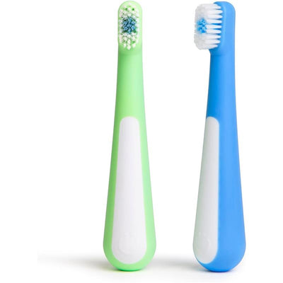 Toddler training toothbrush set featuring a green and blue toothbrush with soft bristles and ergonomic design.