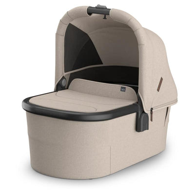 Uppababy Bassinet V3 in Sandstone Melange with Chestnut Leather accents, designed for safe infant sleeping.