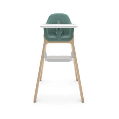 Uppababy Ciro Highchair in Emrick Spruce Green with a white tray and wooden legs, designed for feeding infants.