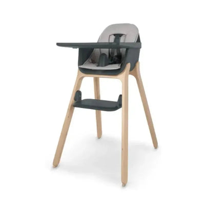 Uppababy Ciro highchair with a gray seat cushion and wooden legs, featuring a removable tray and footrest.