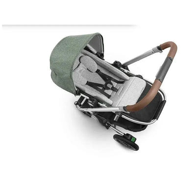 UPPAbaby Infant Snugseat in Grey, featuring a padded seat with safety straps and a green canopy on a stroller frame.