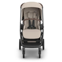 Uppababy Kona Stroller in Sandstone Mélange, featuring a cushioned seat, harness, and adjustable canopy, designed for child comfort.