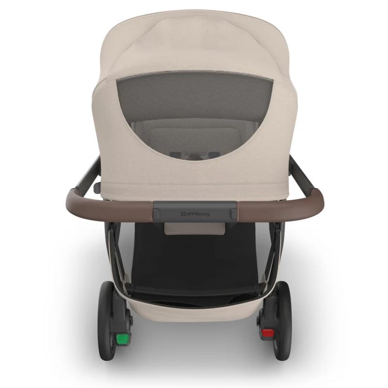 Uppababy Kona Stroller in Sandstone Mélange, featuring a mesh back, brown handlebar, and rear wheels with green and red buttons.