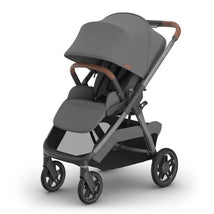 Uppababy Kona Stroller in Rowan (Graphite) color, featuring a spacious seat, large canopy, and brown handlebar accents.