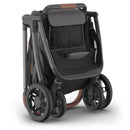 Uppababy Kona Stroller in Rowan (Graphite) with a sleek black seat, adjustable canopy, and large wheels for smooth mobility.